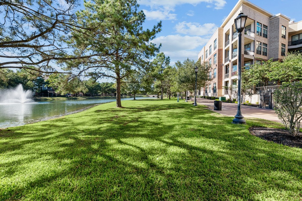 A fountain in a park next to a building.