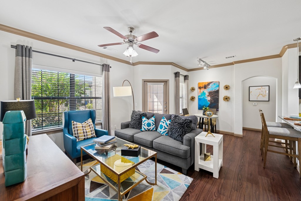 A living room with a grey couch and a yellow coffee table.