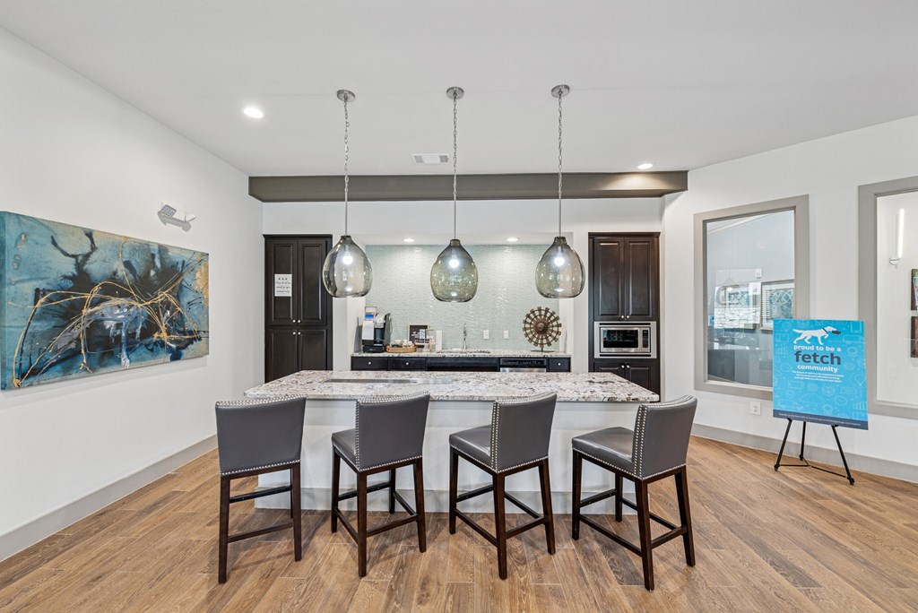 A kitchen with a dining table and chairs.