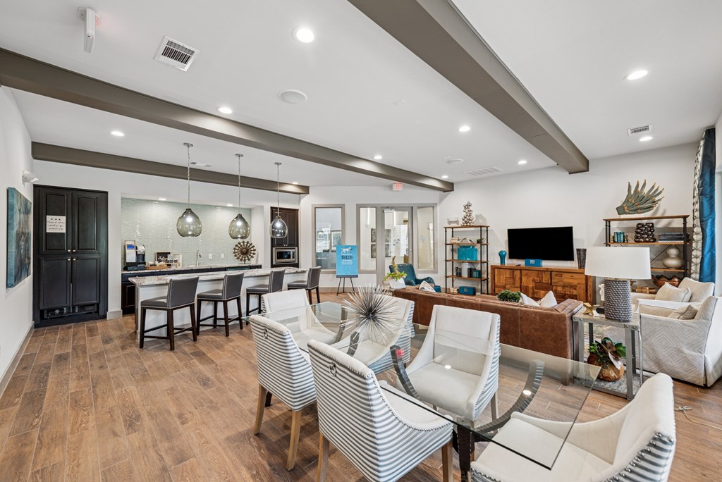 A modern living room with a dining area and a kitchen in the background.