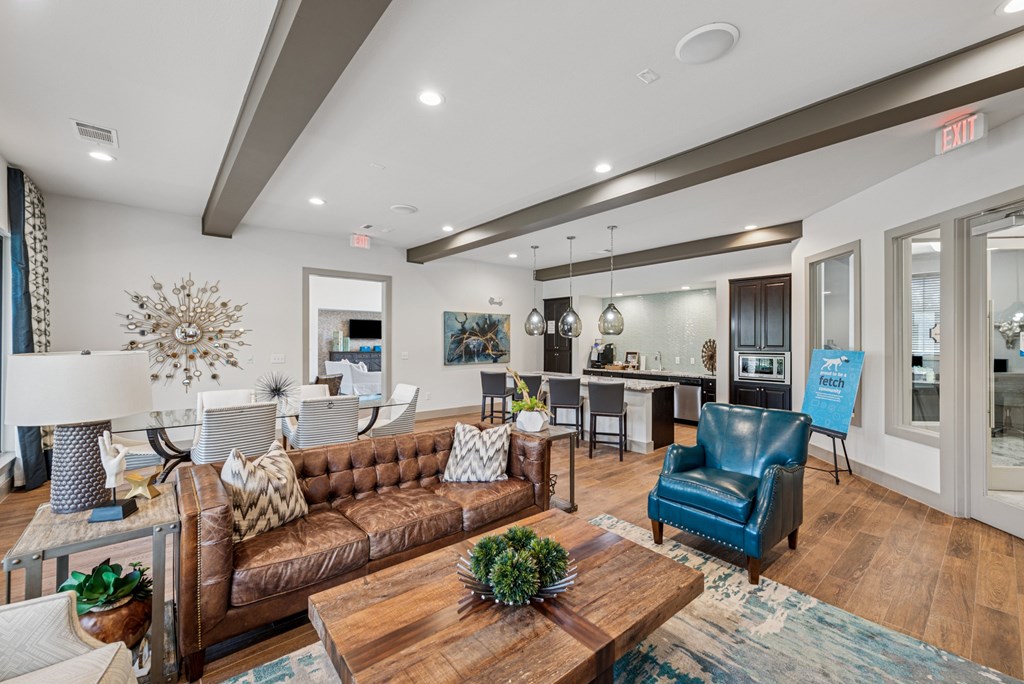 A living room with a brown couch and a blue chair.