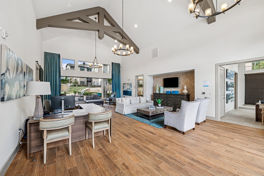 A modern living room with a fireplace and a large painting on the wall.