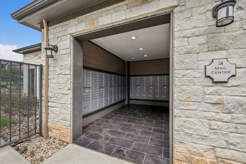 A mail center is located in a stone building with a large, open door.