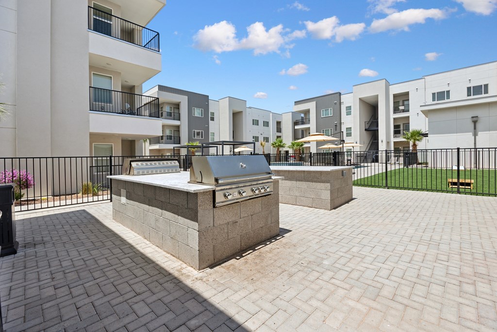 A sunny day at a residential complex with a fountain in the center.