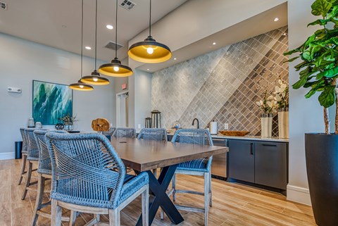 A dining room with a table and chairs.