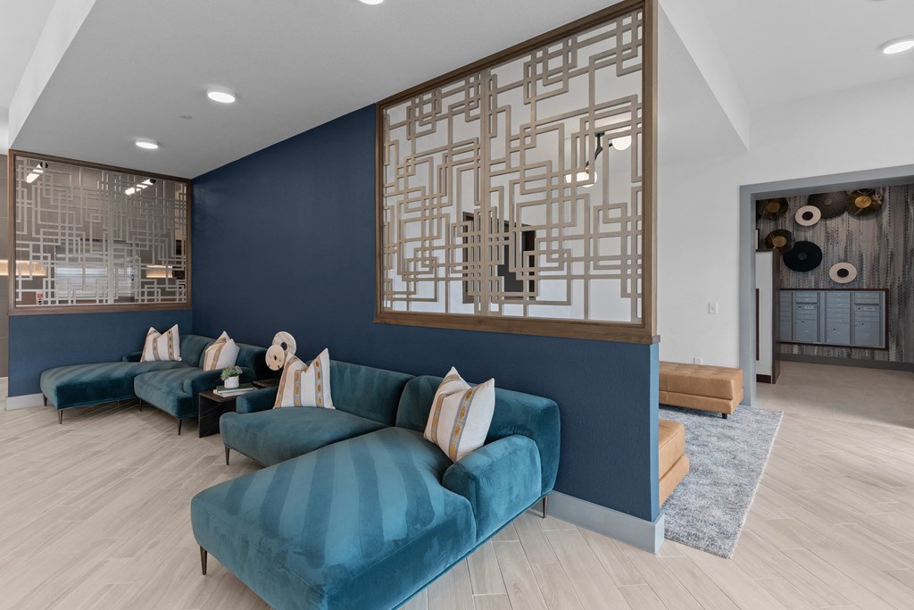 a living room with blue couches and a blue accent wall