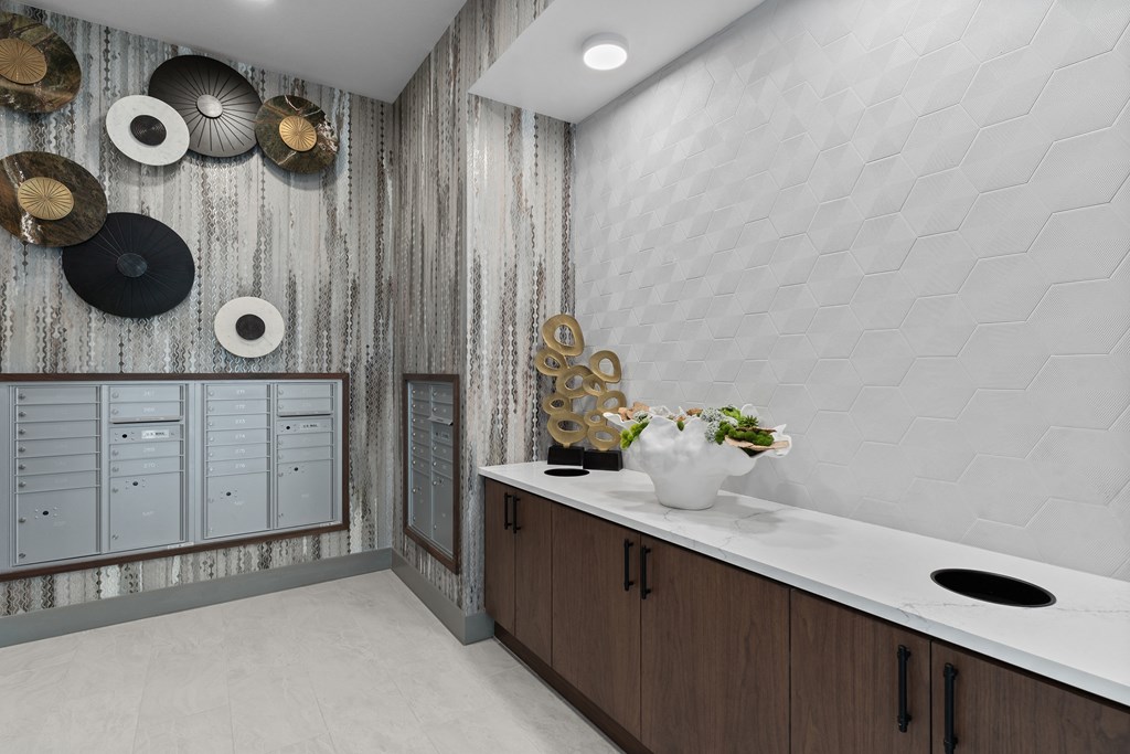 a bathroom with a long counter with a sink and a mirror