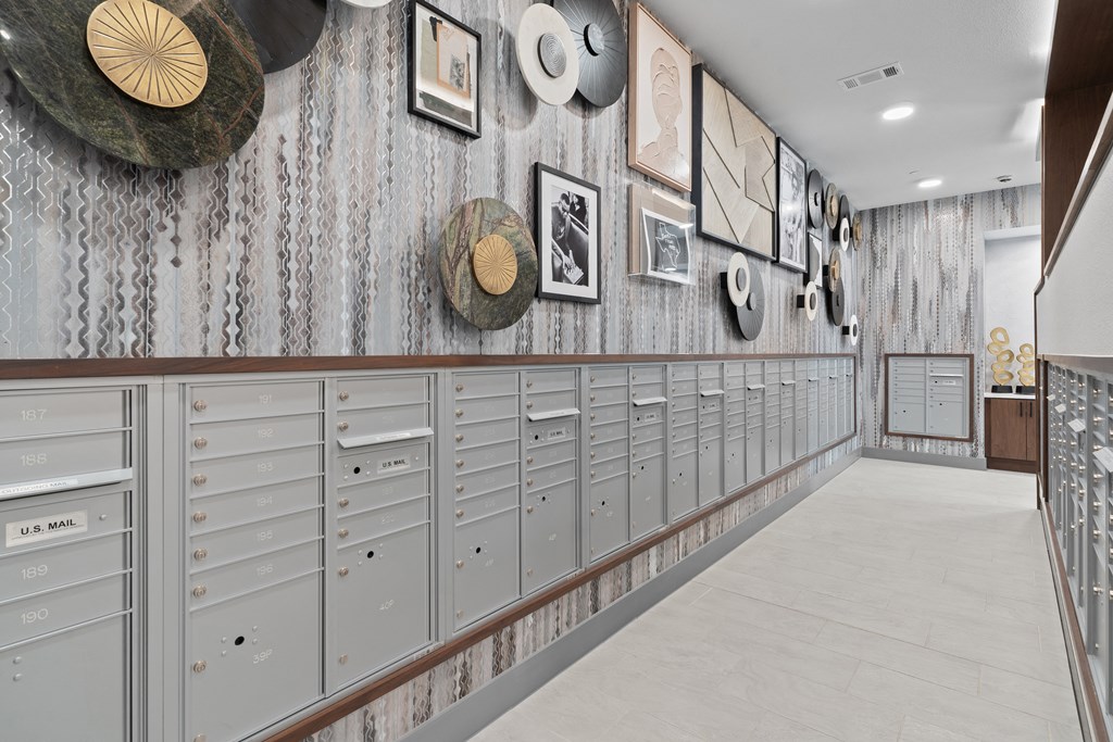a row of lockers in a building with pictures on the wall