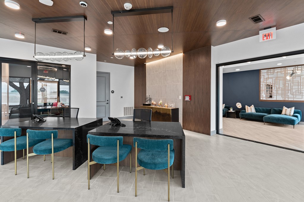 a dining room with blue chairs and a black table