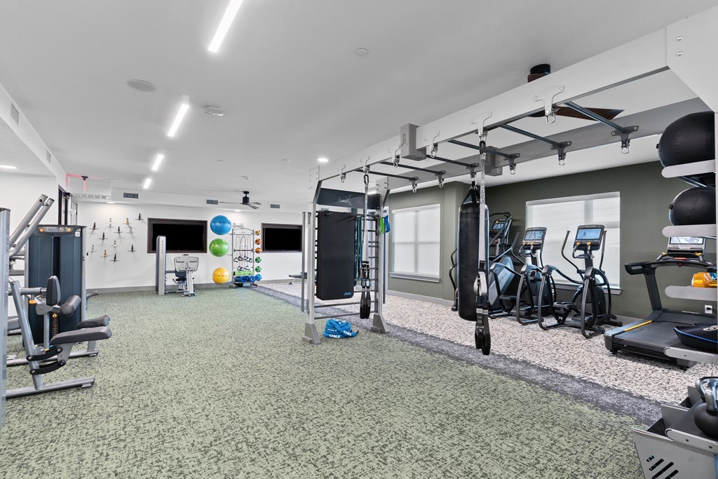 a gym with weights and exercise equipment in a building