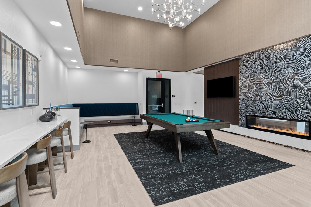 a clubhouse with a pool table and a fireplace
