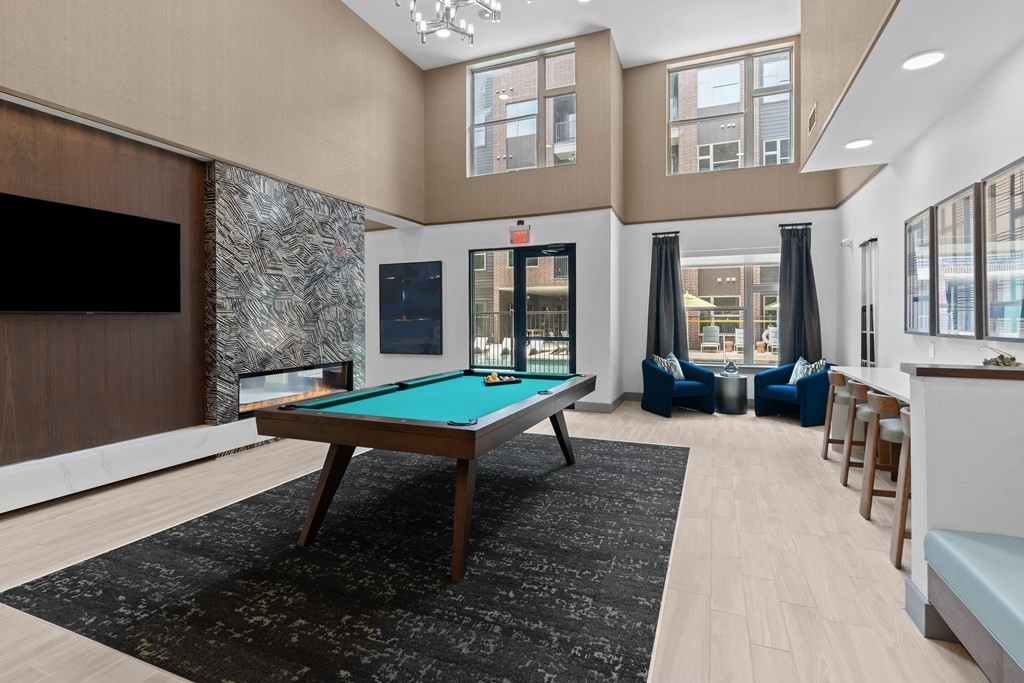 a clubhouse with a pool table and a tv