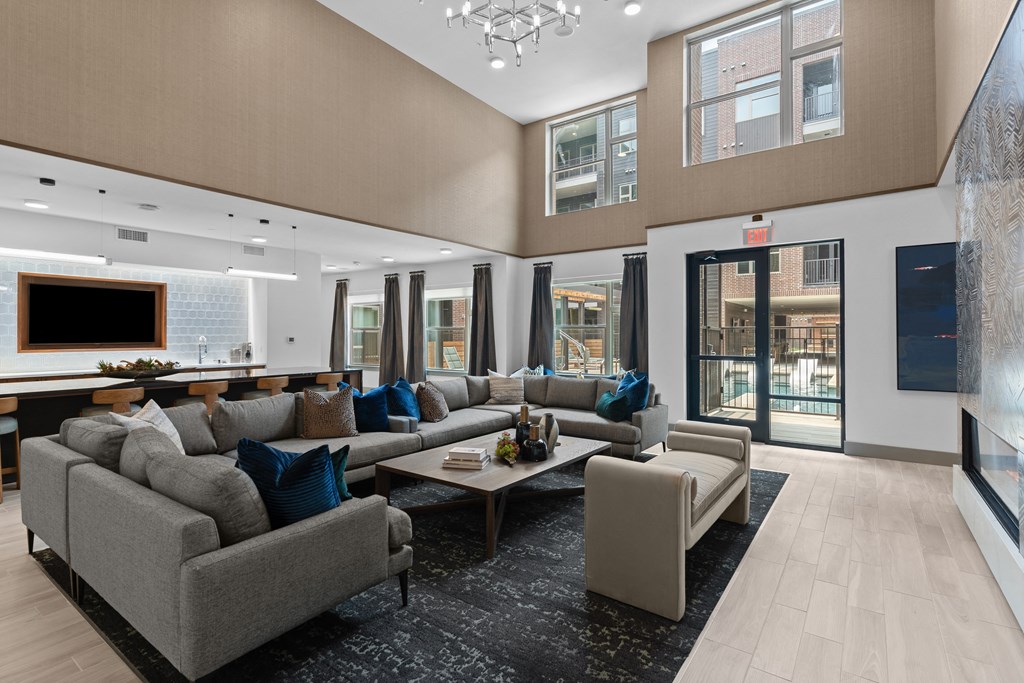 a large living room with couches and chairs and a table