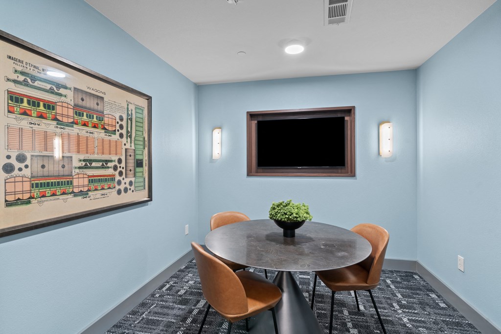 a conference room with blue walls and a table and chairs