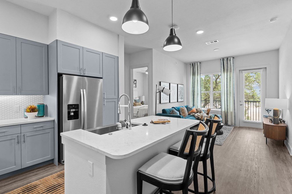 a kitchen with a large island and a living room