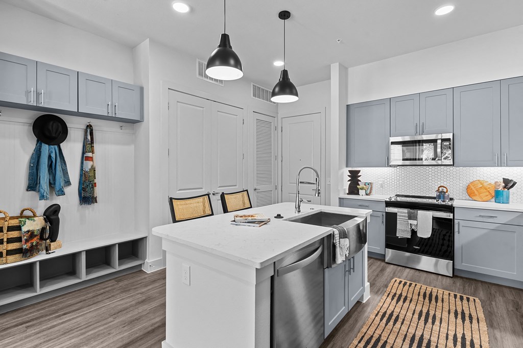 an open kitchen with an island and stainless steel appliances