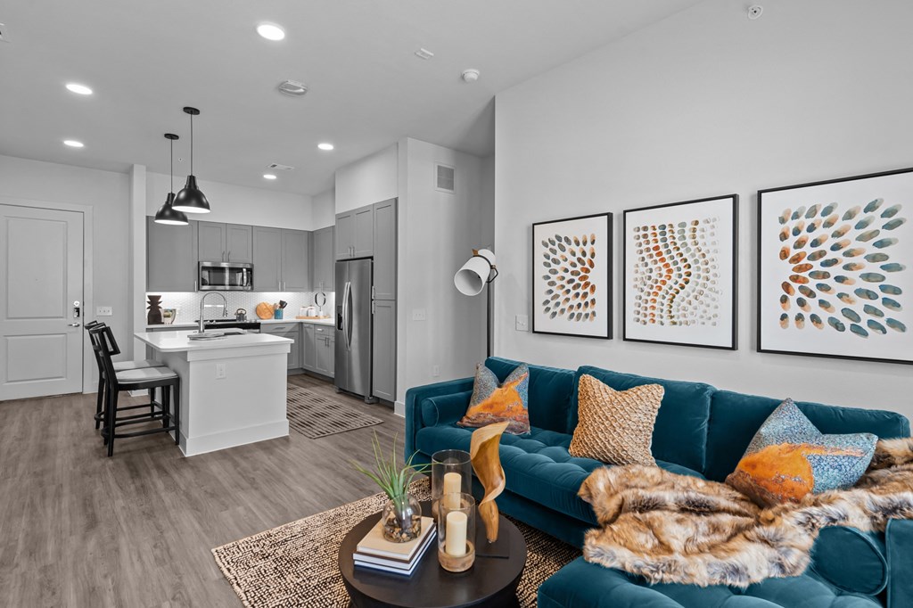an open living room and kitchen with a blue couch