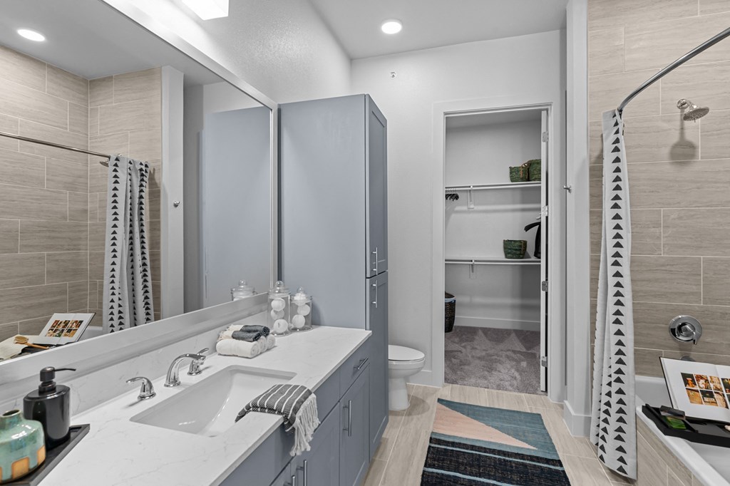 a bathroom with a shower and a sink and a mirror