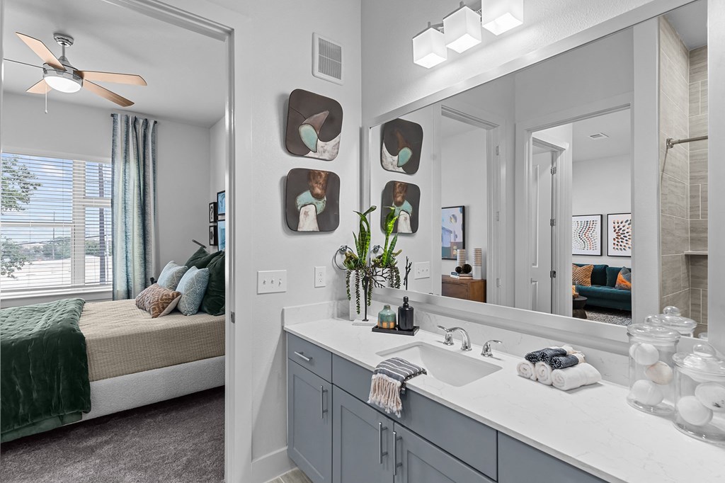 an open bathroom with a large mirror and a sink