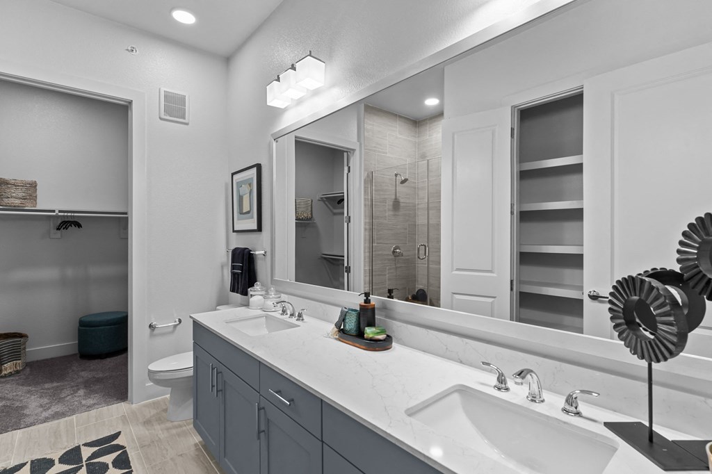 a bathroom with two sinks and a large mirror