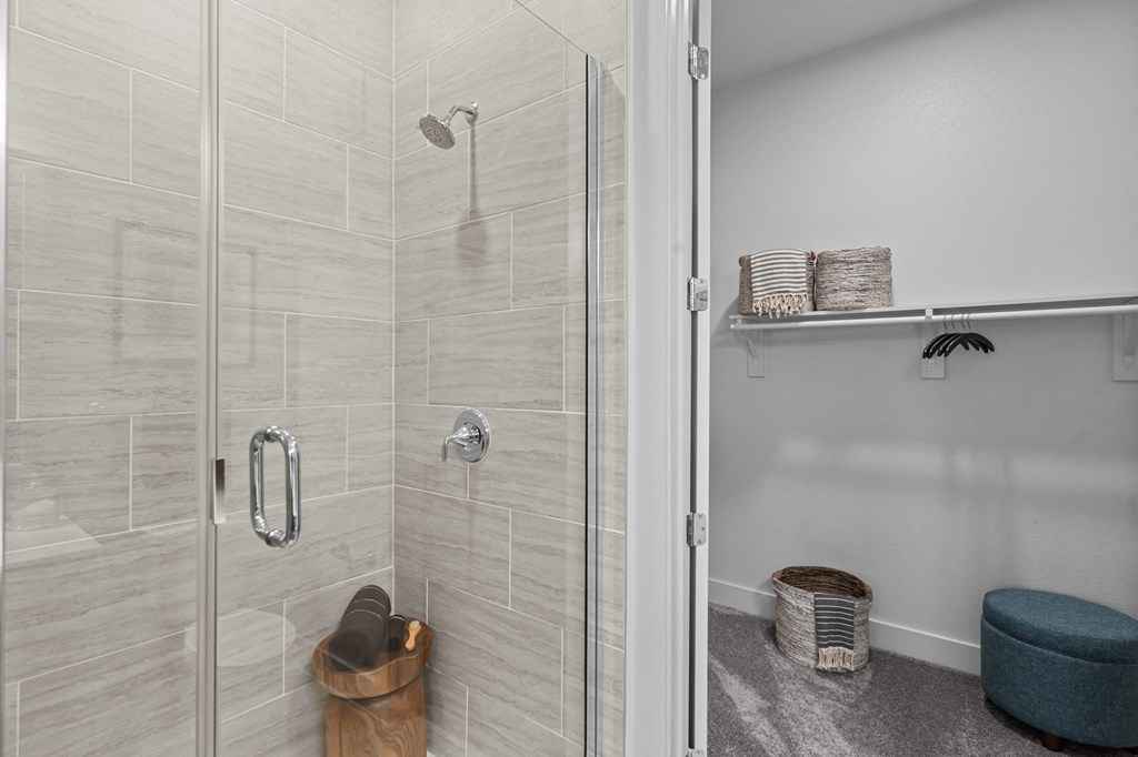 a walk in shower with a glass door in a bathroom
