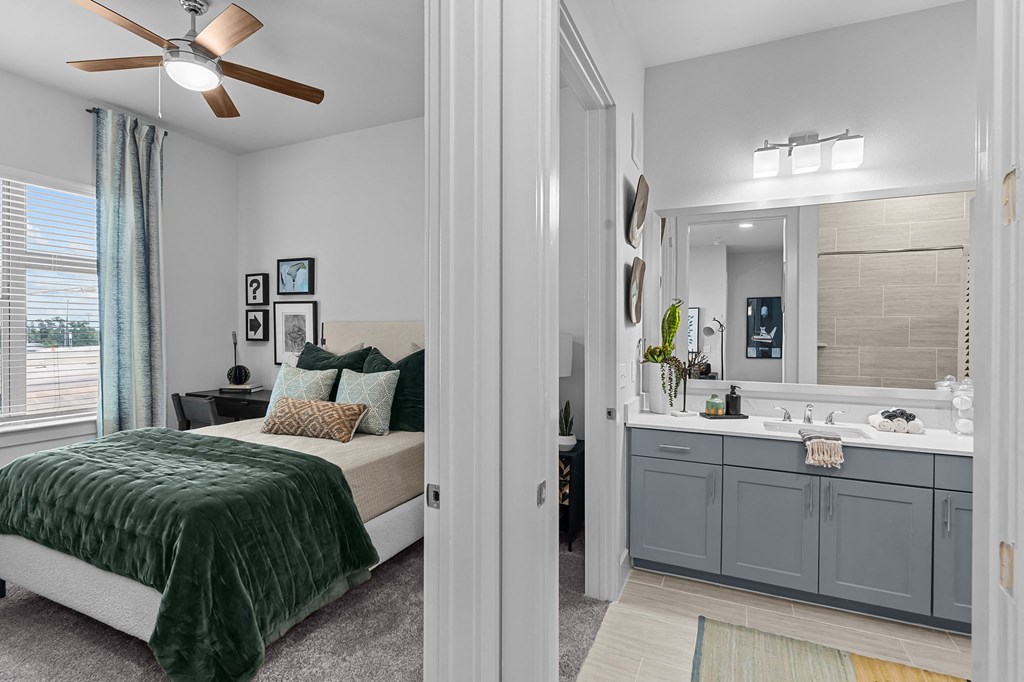 a bedroom with a bed and a bathroom with a sink