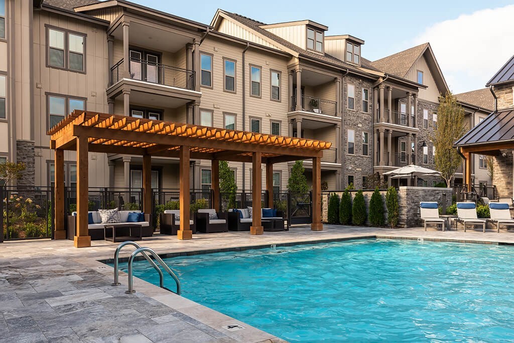 A large, modern building with a pool in front.