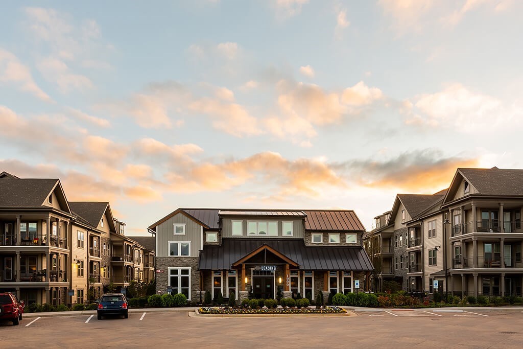 A large building with a parking lot in front of it.