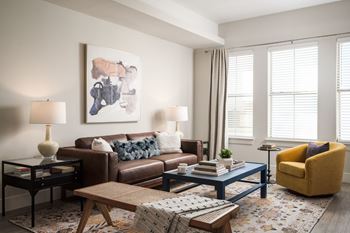 A living room with a yellow chair and a blue coffee table.