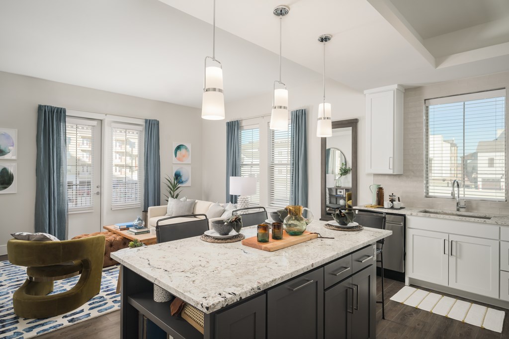 A modern kitchen with a marble countertop and a large island.