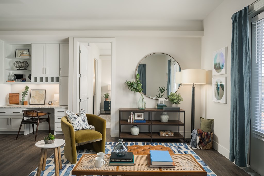 A living room with a yellow chair and a coffee table.