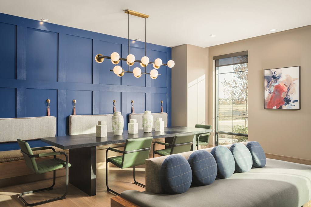 A modern living room with blue walls and furniture.