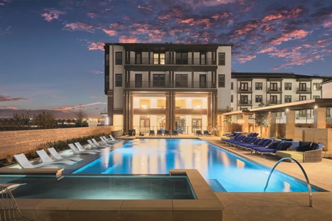 A large swimming pool in front of a modern building.