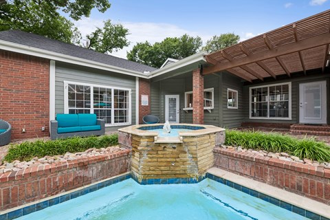 A small house with a pool in the backyard.