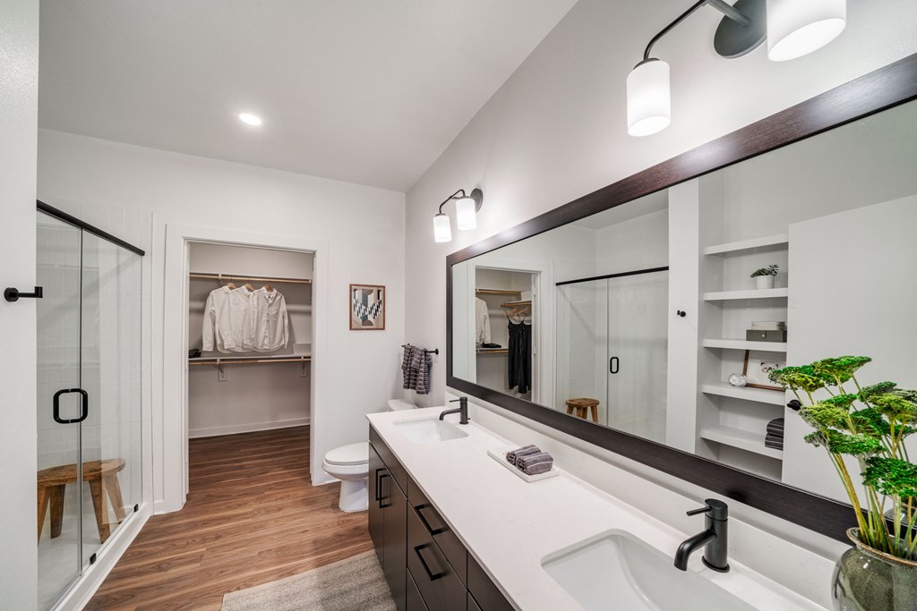 A bathroom with a white sink and a mirror above it.
