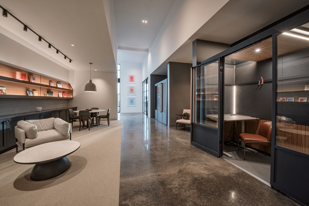 A modern living room with a white couch and a round table.