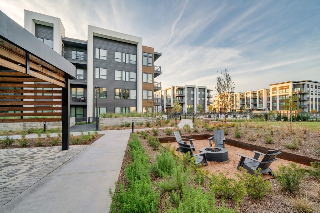 A modern building with a garden in front.