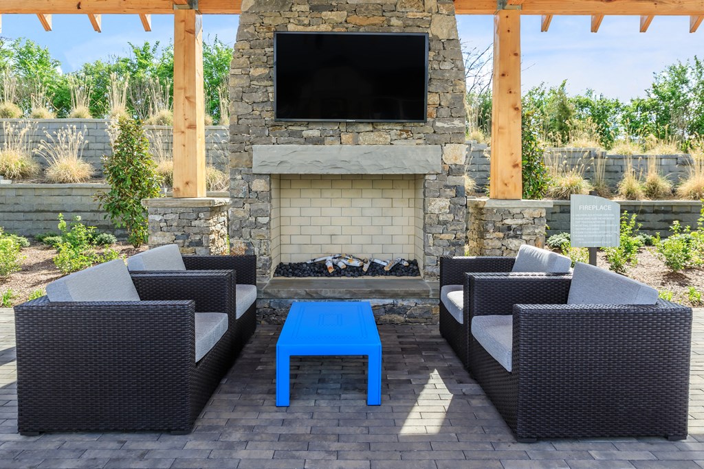 A patio with a fireplace and seating area.