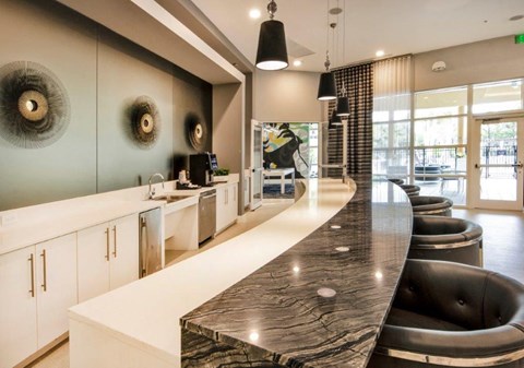 a kitchen with a long counter and a long table