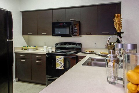 a kitchen with black appliances and a counter top