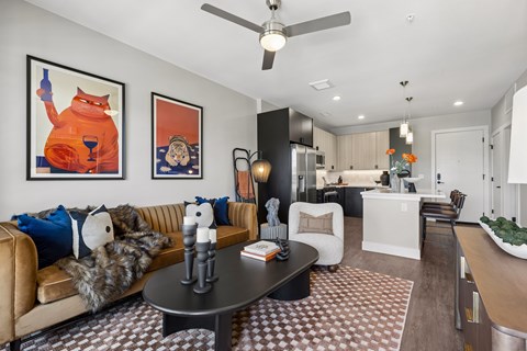 A living room with a brown and white checkered rug and a brown leather couch.