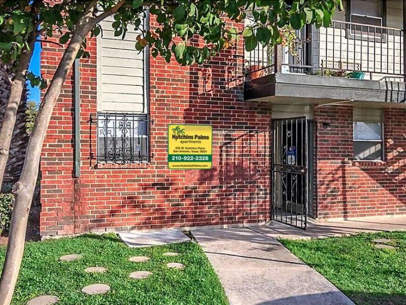 a brick building with a yellow sign on the side of it