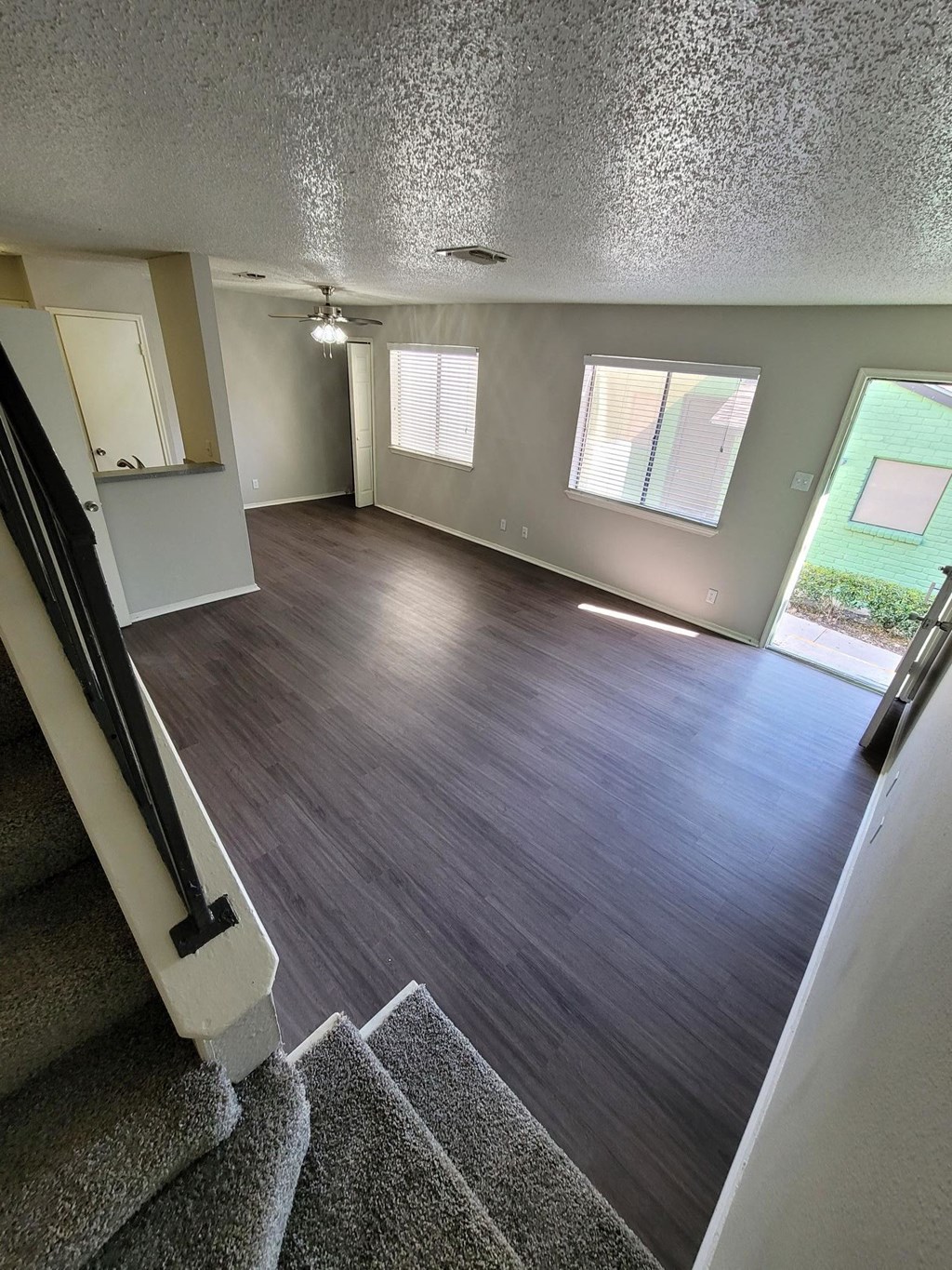 a view of a living room from the top of the stairs