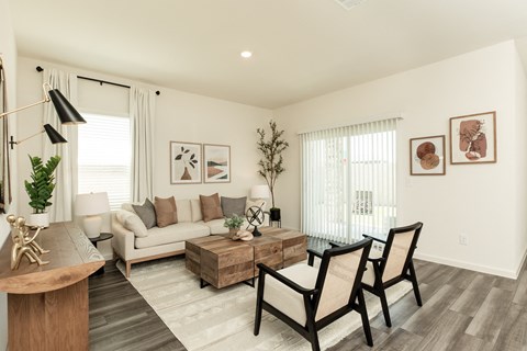 A living room with a couch, chairs, and a coffee table.