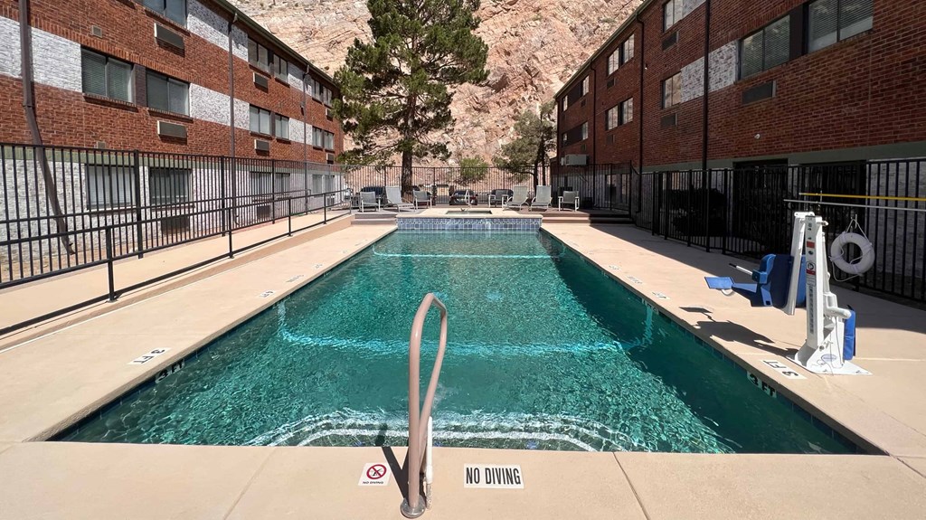 a swimming pool with a mountain in the background