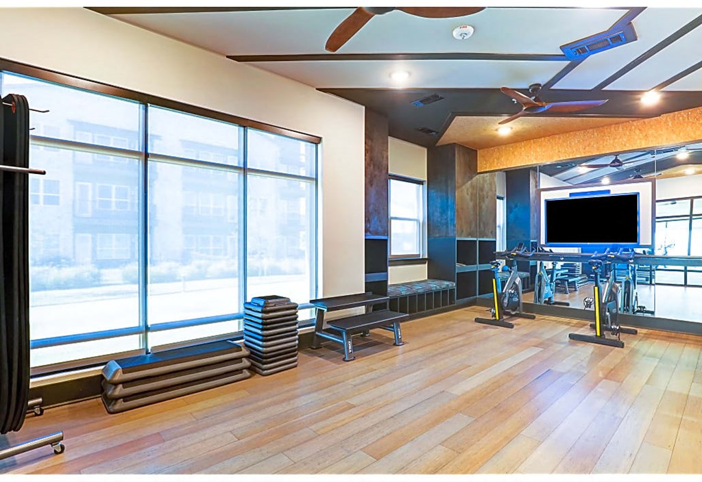 A room with a wooden floor and a ceiling fan.