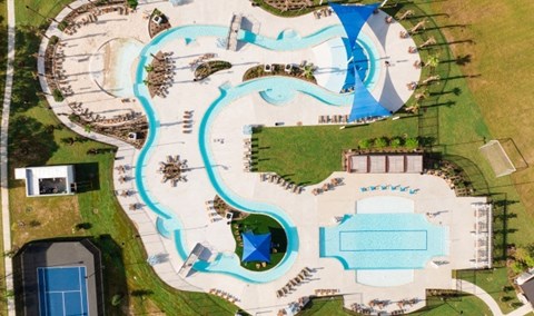 A large outdoor swimming pool complex with a lazy river and multiple pools.