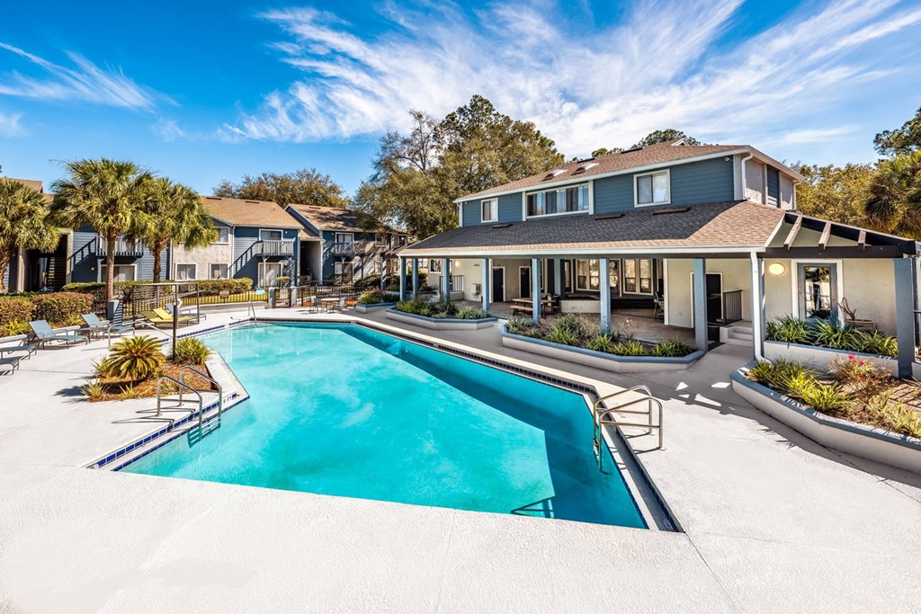 A swimming pool in front of a house.