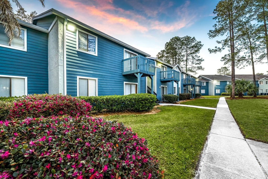 A blue building with a white walkway in front.