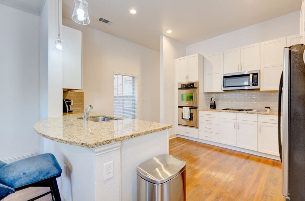a kitchen with white cabinets and a counter top